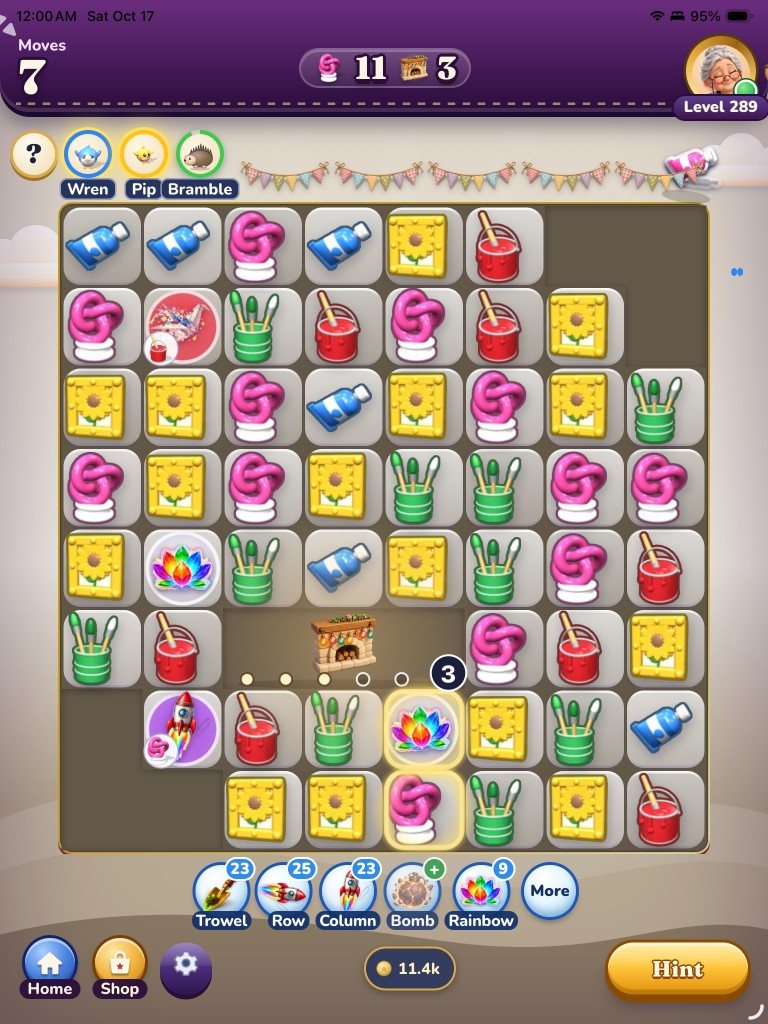 A level on iPad: paint tubes, sunflower frames and a Rainbow piece on the board, with the Trowel, Row, Column, Bomb and Rainbow helpers below